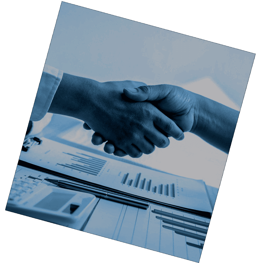 Dos personas estrechando manos sobre un escritorio con una calculadora.